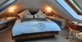 Ferienhaus Max Schlafzimmer mit doppelbett und zwei Dachfenstern