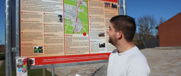 Andre Janssen vor dem touristischen Hinweisschild der Stadt